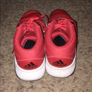 Red high top adidas running shoes